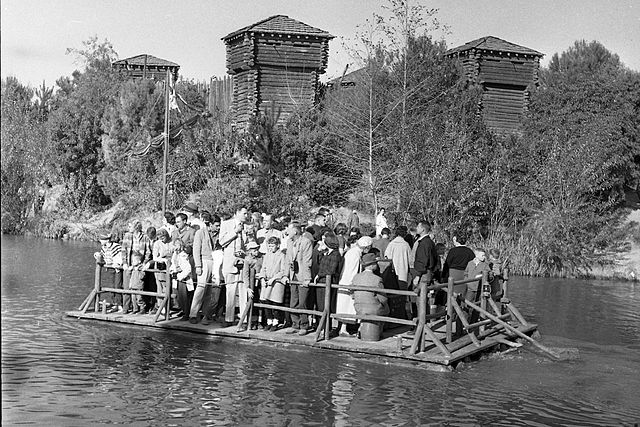 Photo of people on a raft to Tom Sawyer Island at Disneyland, about 1960