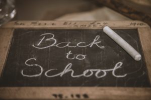 image of wood-framed chalkboard with words back to school written on it