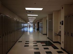 image of school hallways with one student in it