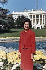 Photo of Lady Bird Johnson in red skirt suit
