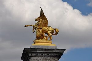 Photo of golden statue of Pegasus atop a famous hstorical building in France
