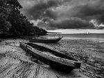 Stormy dawn with broken boats washed up on a beach
