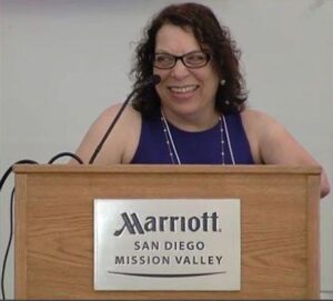 Photo of Karen delivering an inspiring keynote at a disability rights conference